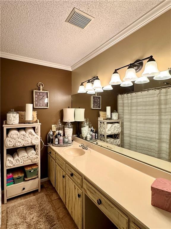 270 Owens Cir NE, Calhoun, GA 30701 - full bath featuring ornamental molding, a textured ceiling, vanity, and tile patterned floors