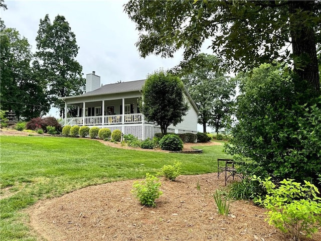 270 Owens Cir NE, Calhoun, GA 30701 - rear view of property featuring a chimney, covered porch, a lawn, and metal roof