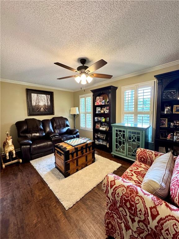 270 Owens Cir NE, Calhoun, GA 30701 - living room featuring plenty of natural light, dark wood-style floors, a ceiling fan, a textured ceiling, and ornamental molding