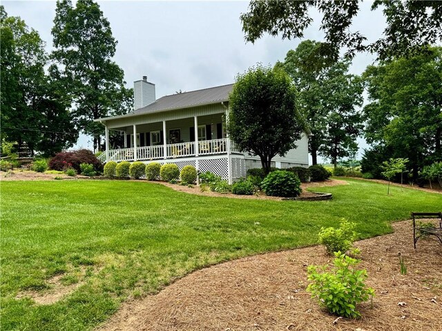 270 Owens Cir NE, Calhoun, GA 30701 - view of side of property with a chimney, a porch, a lawn, and metal roof