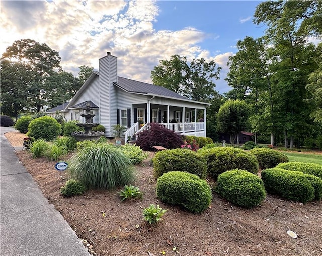 270 Owens Cir NE, Calhoun, GA 30701 - view of front of home featuring a porch, a chimney, and metal roof
