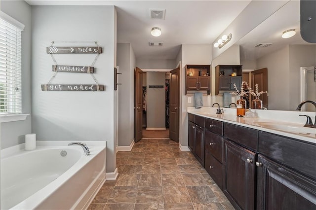 bathroom with vanity and a bathtub