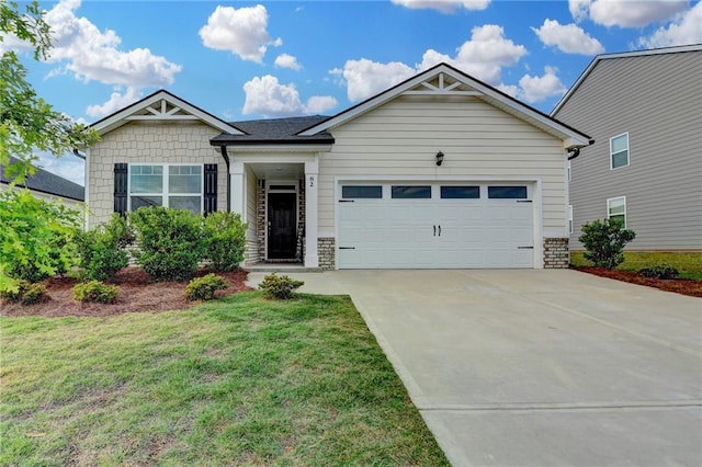 82 Graham Campbell Ln, Statham, GA 30666 - view of front of home with driveway, a garage, a front yard, and stone siding