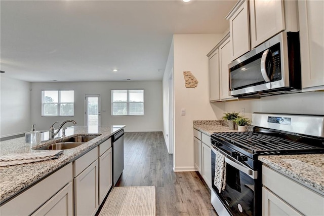 82 Graham Campbell Ln, Statham, GA 30666 - kitchen with appliances with stainless steel finishes, a sink, light wood-style flooring, recessed lighting, and light stone counters