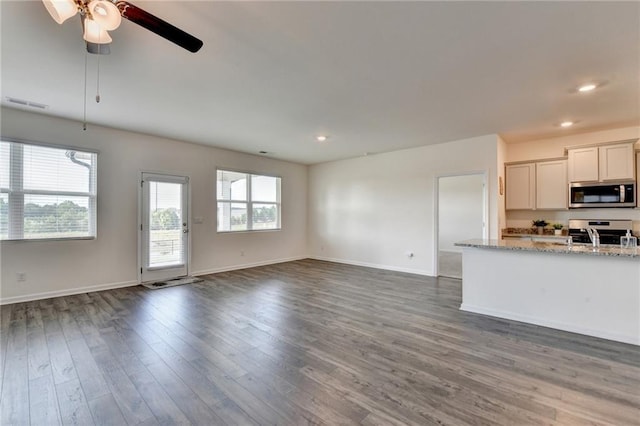 82 Graham Campbell Ln, Statham, GA 30666 - unfurnished living room with dark wood finished floors, baseboards, a ceiling fan, and recessed lighting