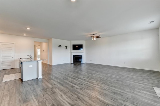 82 Graham Campbell Ln, Statham, GA 30666 - unfurnished living room with a sink, ceiling fan, dark wood-style flooring, recessed lighting, and baseboards