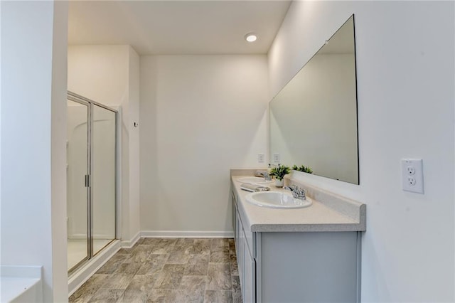 82 Graham Campbell Ln, Statham, GA 30666 - bathroom with double vanity, a shower stall, baseboards, and a tub to relax in