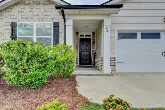 82 Graham Campbell Ln, Statham, GA 30666 - view of exterior entry with an attached garage