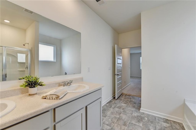82 Graham Campbell Ln, Statham, GA 30666 - full bathroom featuring double vanity, baseboards, a stall shower, a bath, and stone finish flooring