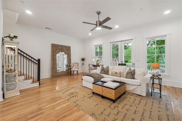 living room featuring ceiling fan and light hardwood / wood-style flooring