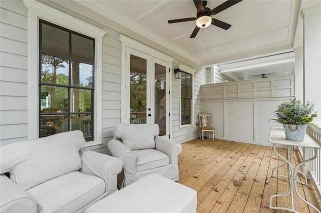 sunroom / solarium featuring ceiling fan