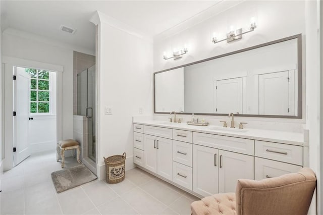 bathroom with an enclosed shower, vanity, tile patterned floors, and crown molding