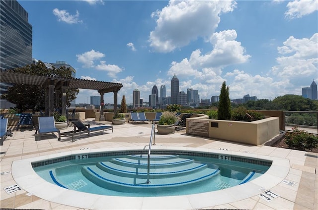 view of pool with a view of city, a patio area, and a pergola