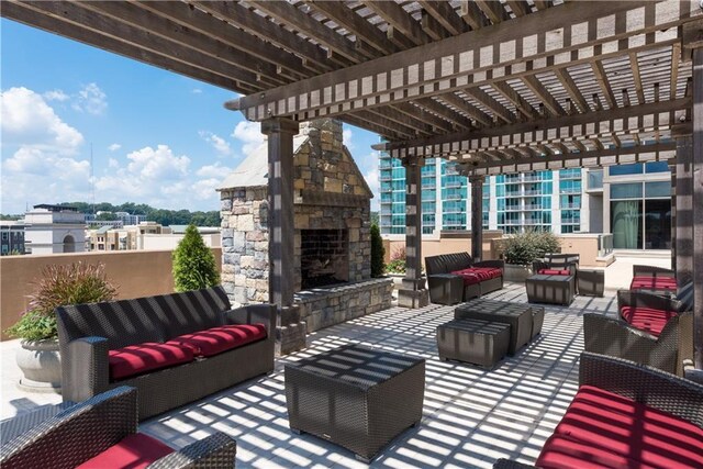 view of patio with an outdoor living space with a fireplace and a pergola