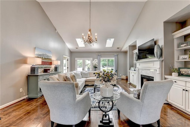 510 Elgaen Ct, Roswell, GA 30075 - living area featuring high vaulted ceiling, a skylight, a high end fireplace, wood finished floors, and a chandelier