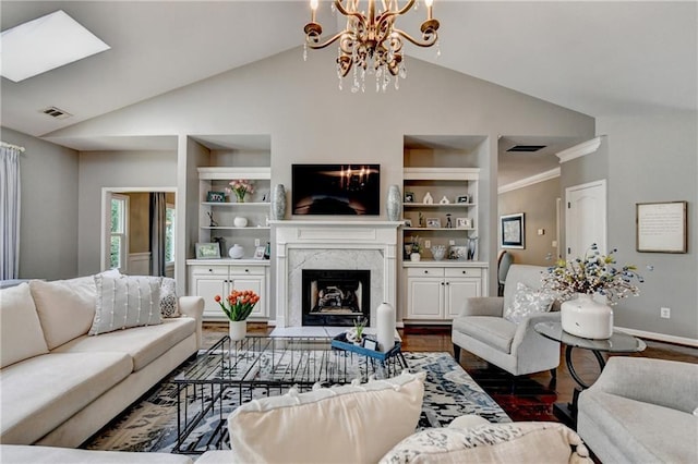 510 Elgaen Ct, Roswell, GA 30075 - living area with a chandelier, wood finished floors, built in shelves, a fireplace, and high vaulted ceiling