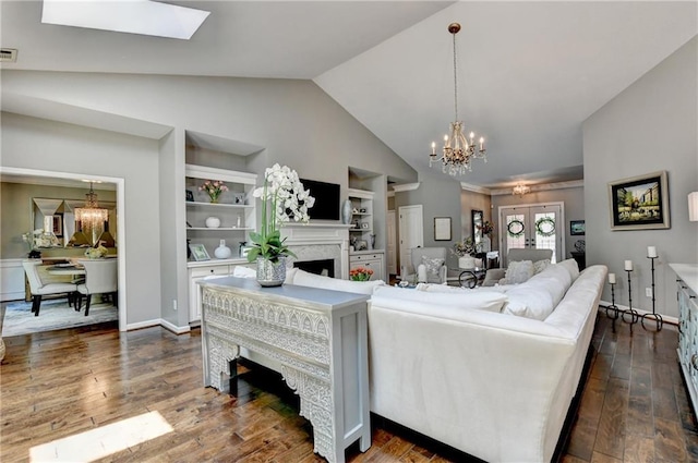 510 Elgaen Ct, Roswell, GA 30075 - living area with a chandelier, built in shelves, a fireplace, dark wood-type flooring, and high vaulted ceiling