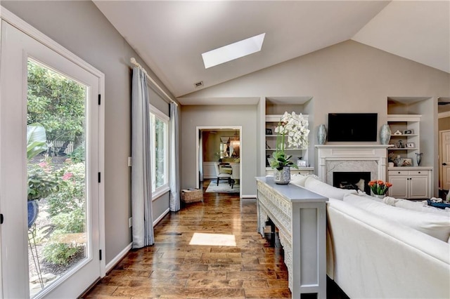 510 Elgaen Ct, Roswell, GA 30075 - living area with a skylight, vaulted ceiling, wood finished floors, a fireplace, and plenty of natural light