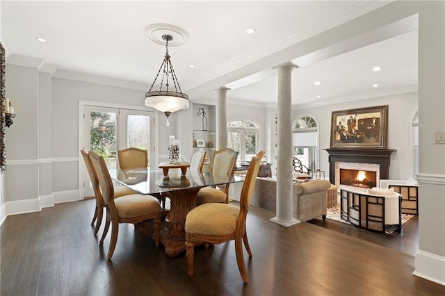 dining room with decorative columns, crown molding, french doors, and dark hardwood / wood-style flooring