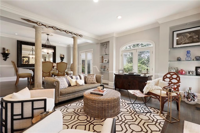 sitting room with dark hardwood / wood-style flooring, crown molding, and decorative columns