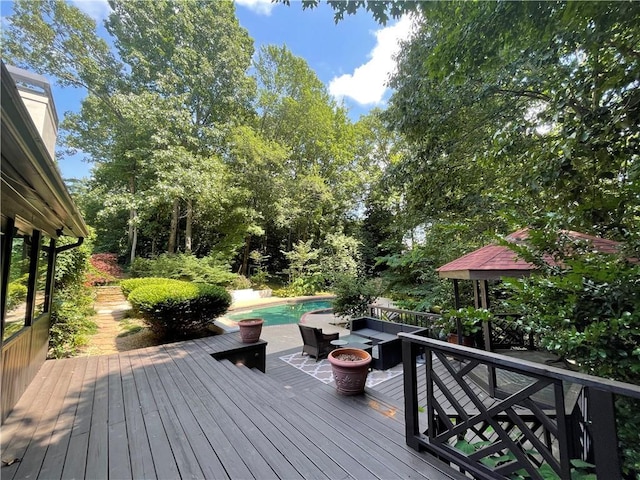 wooden deck with an outdoor fire pit