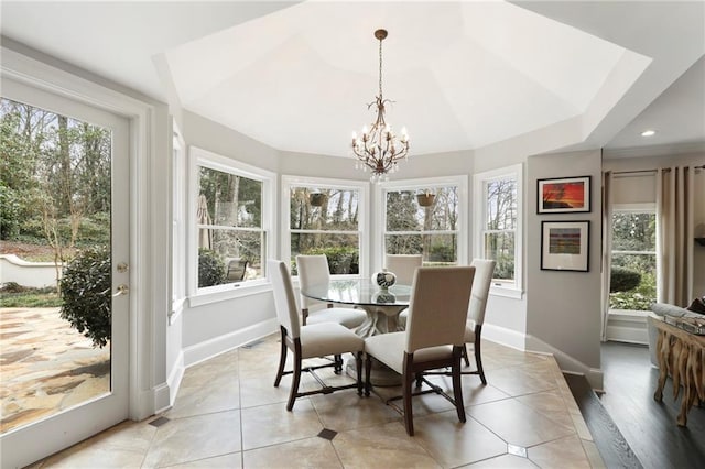 sunroom with a notable chandelier and a tray ceiling