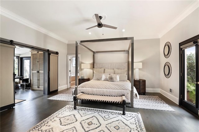 bedroom with a barn door, multiple windows, crown molding, and dark wood-type flooring