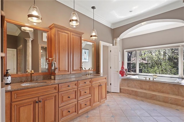 bathroom with tile flooring, tiled tub, dual bowl vanity, ornamental molding, and ornate columns