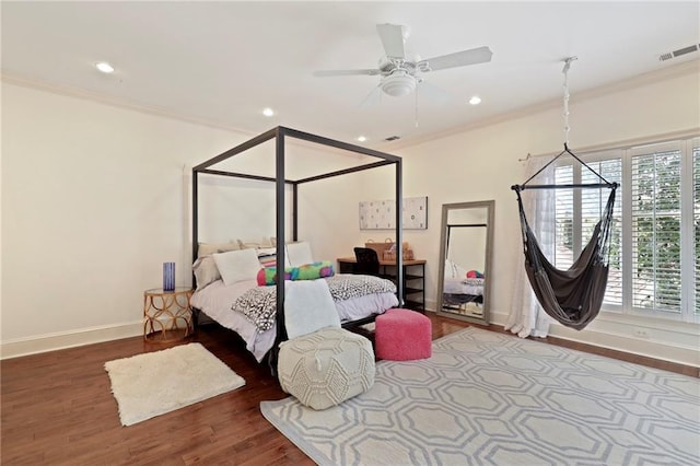 bedroom with dark hardwood / wood-style flooring, ceiling fan, and ornamental molding