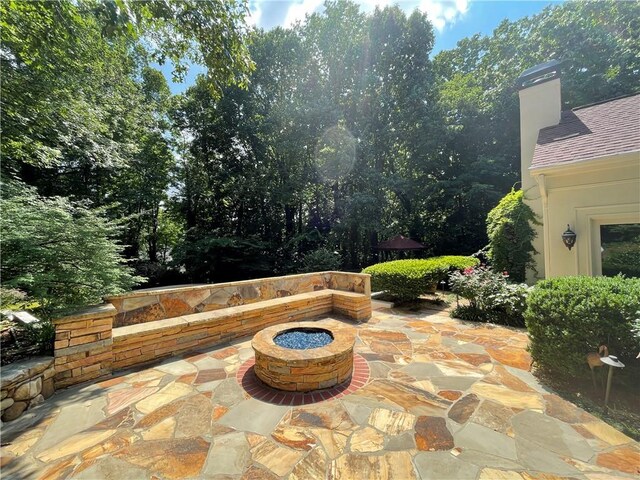 view of patio / terrace with an outdoor fire pit