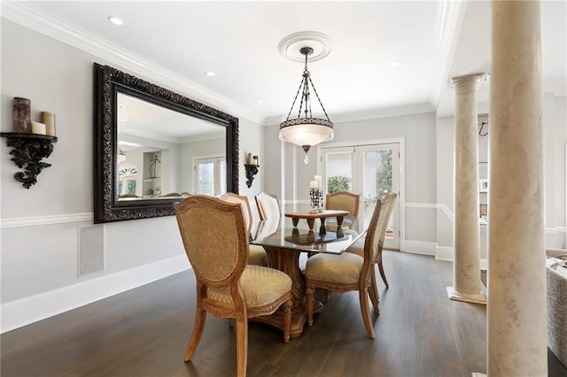 dining room with plenty of natural light, crown molding, dark hardwood / wood-style floors, and decorative columns