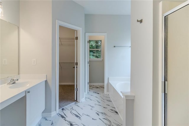 6118 Arbor Links Rd, Lithonia, GA 30058 - bathroom featuring marble look tile flooring, vanity, a bath, a shower stall, and a spacious closet