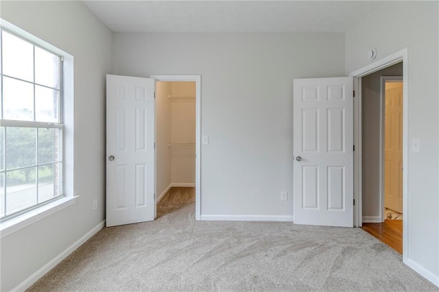 6118 Arbor Links Rd, Lithonia, GA 30058 - unfurnished bedroom with carpet flooring, a walk in closet, and a closet