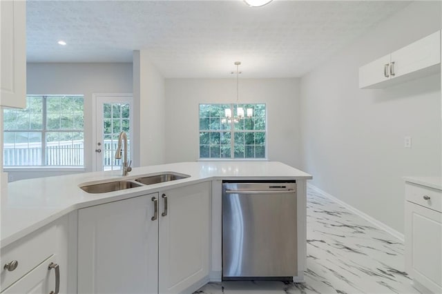 6118 Arbor Links Rd, Lithonia, GA 30058 - kitchen featuring dishwasher, light marble finish flooring, plenty of natural light, light countertops, and a textured ceiling