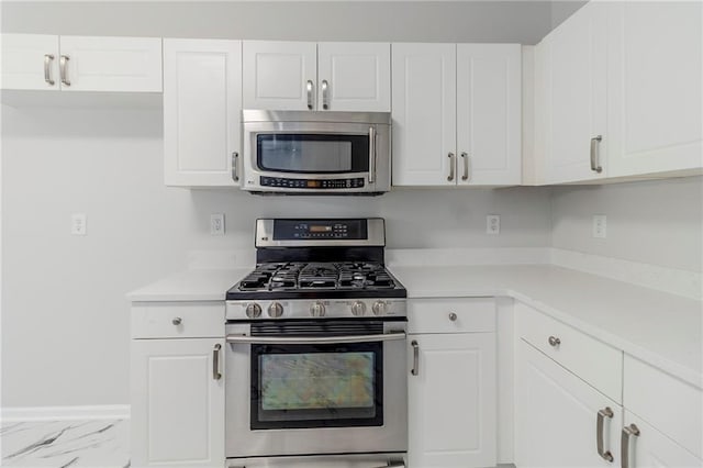 6118 Arbor Links Rd, Lithonia, GA 30058 - kitchen with appliances with stainless steel finishes, light countertops, white cabinetry, and marble look tiles