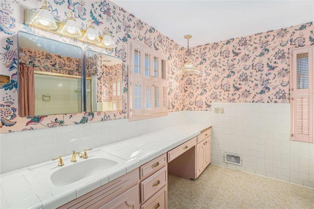 bathroom with tile walls and vanity