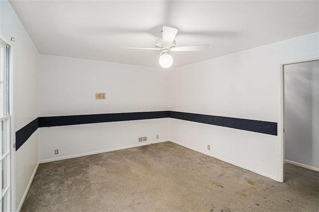 spare room featuring ceiling fan and carpet flooring