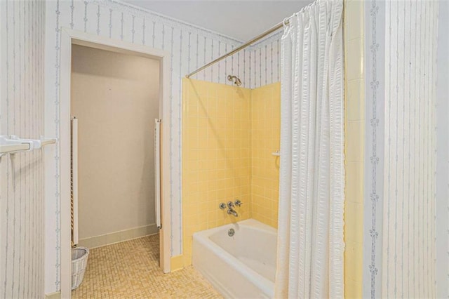 bathroom with shower / bath combination with curtain and tile patterned flooring