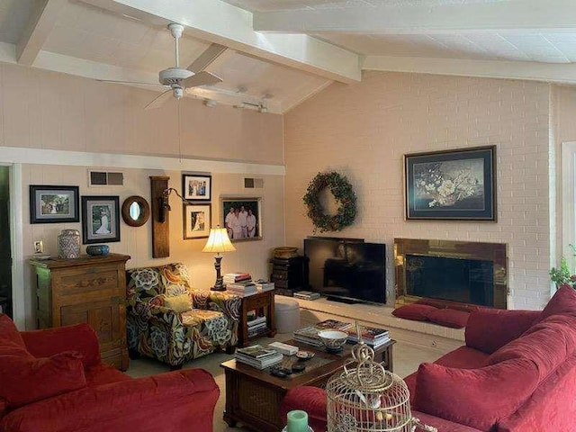 living room featuring lofted ceiling with beams, ceiling fan, and a fireplace