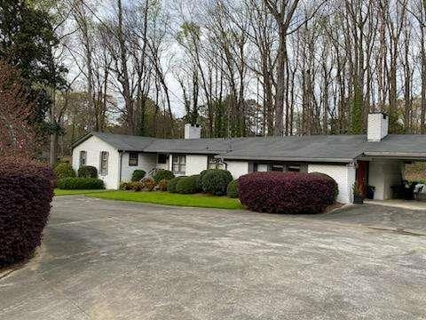 ranch-style home featuring a carport