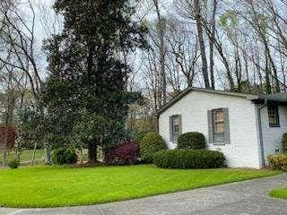 view of home's exterior with a lawn