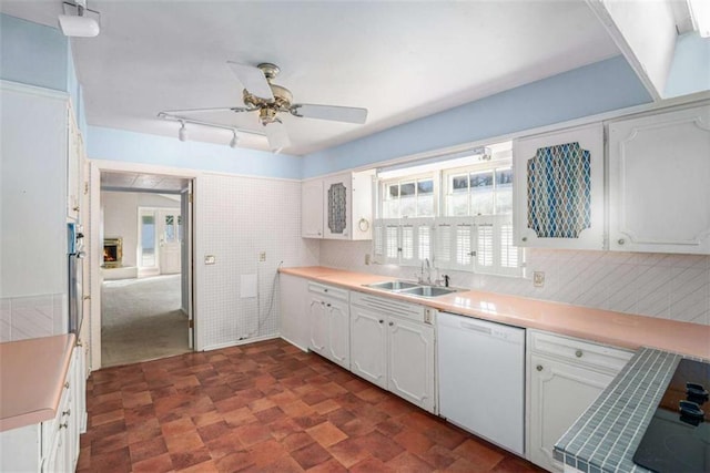 kitchen with white cabinetry, ceiling fan, dishwasher, and sink