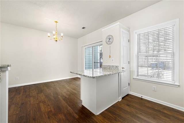4100 Howell Park Rd, Duluth, GA 30096 - kitchen featuring a chandelier, dark wood-style floors, a peninsula, and baseboards