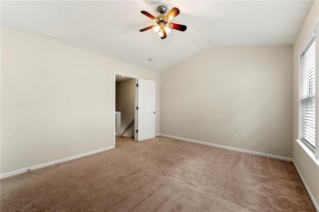 4100 Howell Park Rd, Duluth, GA 30096 - unfurnished bedroom featuring vaulted ceiling, light colored carpet, multiple windows, and baseboards