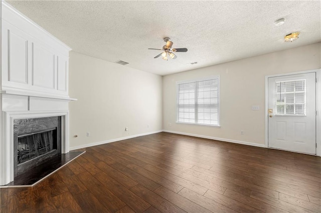 4100 Howell Park Rd, Duluth, GA 30096 - unfurnished living room featuring a textured ceiling, a ceiling fan, baseboards, a fireplace, and healthy amount of natural light