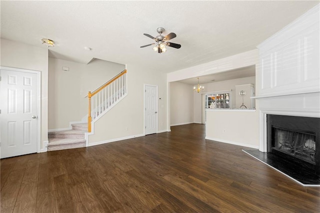 4100 Howell Park Rd, Duluth, GA 30096 - unfurnished living room with a chandelier, a fireplace with raised hearth, ceiling fan, stairs, and wood finished floors