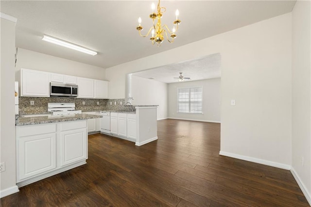 4100 Howell Park Rd, Duluth, GA 30096 - kitchen featuring stainless steel microwave, range, a peninsula, white dishwasher, and a chandelier