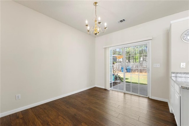 4100 Howell Park Rd, Duluth, GA 30096 - unfurnished dining area featuring a chandelier, dark wood finished floors, baseboards, and vaulted ceiling