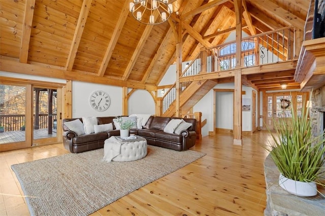 living room with beam ceiling, light wood finished floors, stairway, high vaulted ceiling, and wooden ceiling