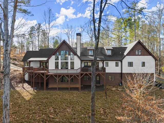 rear view of property featuring a wooden deck